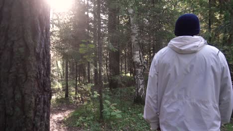 man walking in a forest