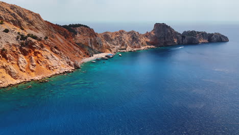coastal views of rugged cliffs. vibrant turquoise waters meet rugged cliffs along a stunning coastline under clear skies, revealing a serene landscape