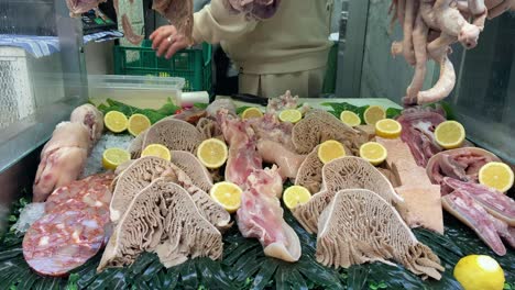 Worker-selling-animal-tripe-in-street-shop-of-Naples,-Italy