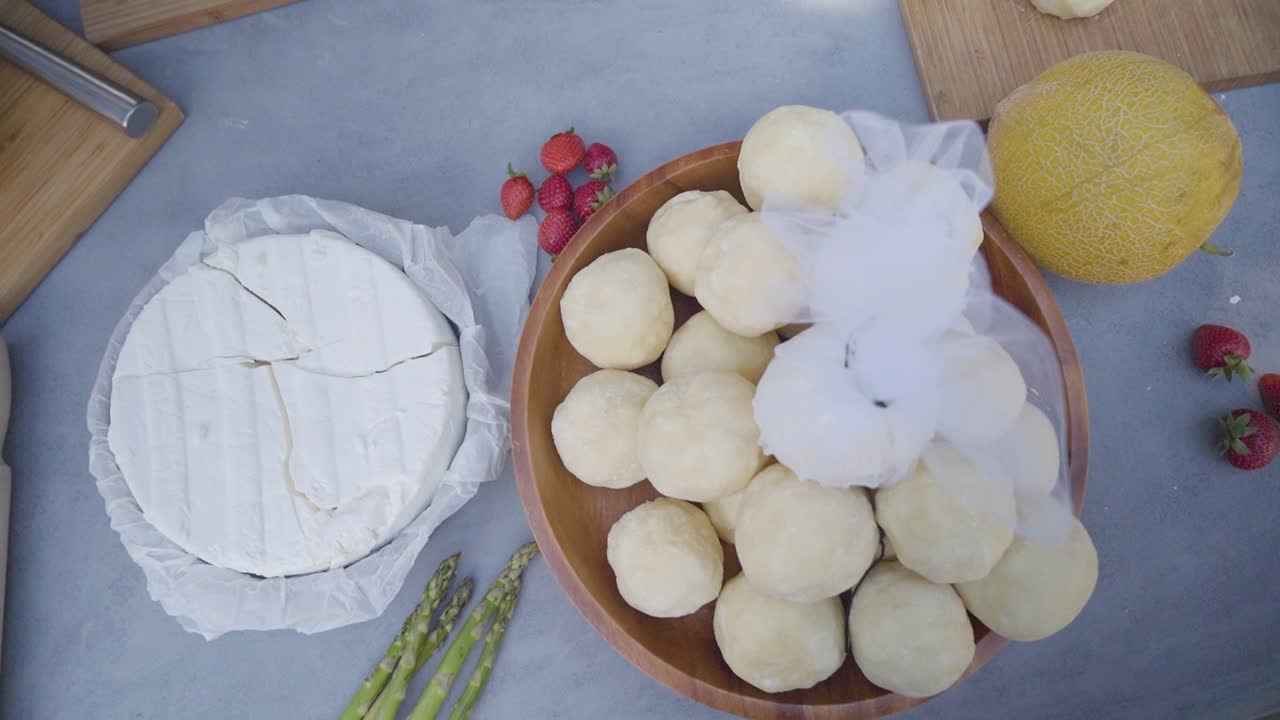 Rotating Top View over Counter with Rustic Traditional Greek Cheeses