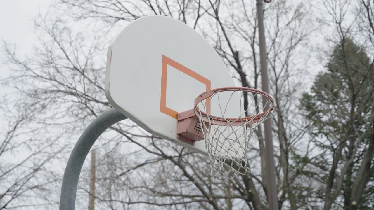 Shooting Ball On Basketball Hoop At Minneapolis Park In USA. - closeup shot