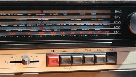 old retro am fm radio with tubes, hand changing stations , bulb vintage music player.