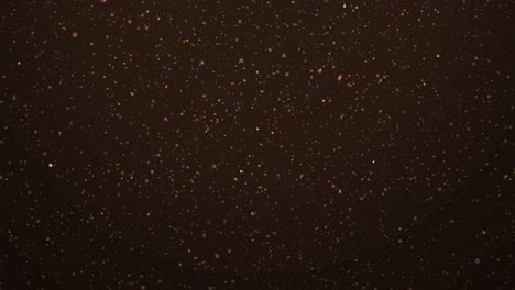 mesmerizing, atmospheric background filled with golden and orange glitter, twinkling lights - glitter shower with rapidly falling sparkles and glowing particles