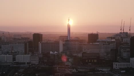 Drone-footage-of-Birmingham,-UK-skyline-at-sunset