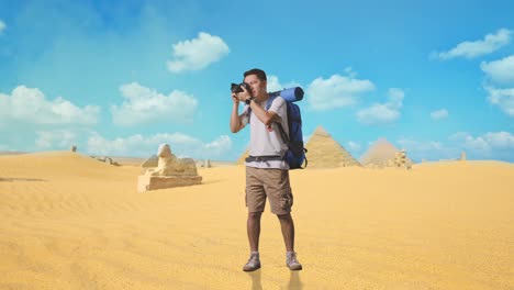 traveler taking photos of the pyramids in the desert