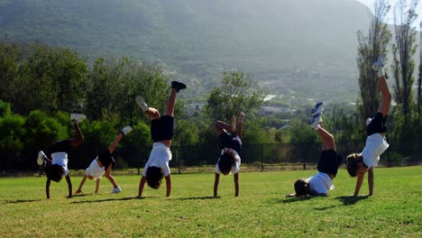 children performing cart wheel during race