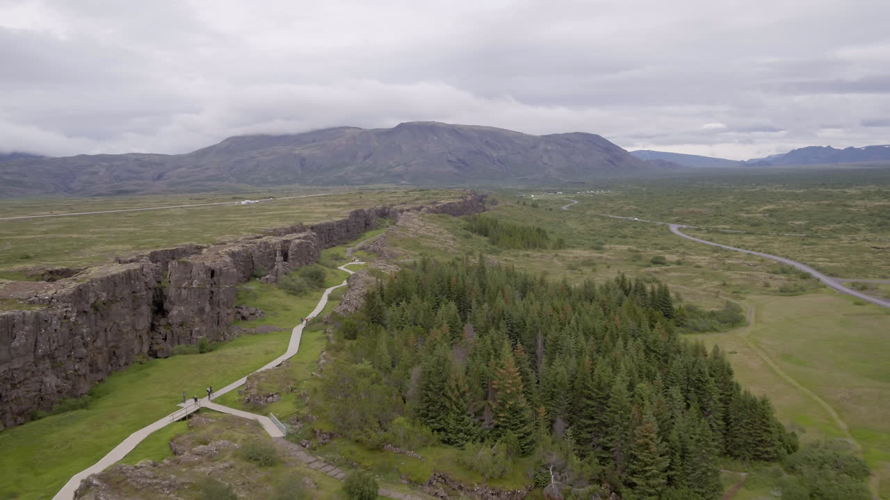 &Ouml;xar&aacute;rfoss waterfall in Iceland aerial track alongside wall and path