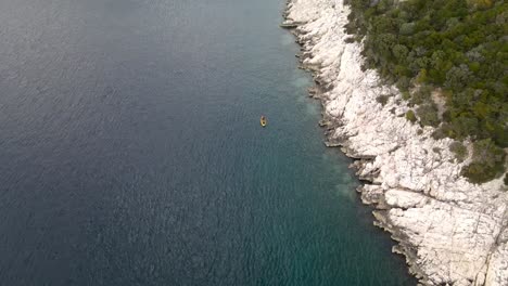 solitary kayak off blue cave beach, cres island, croatia