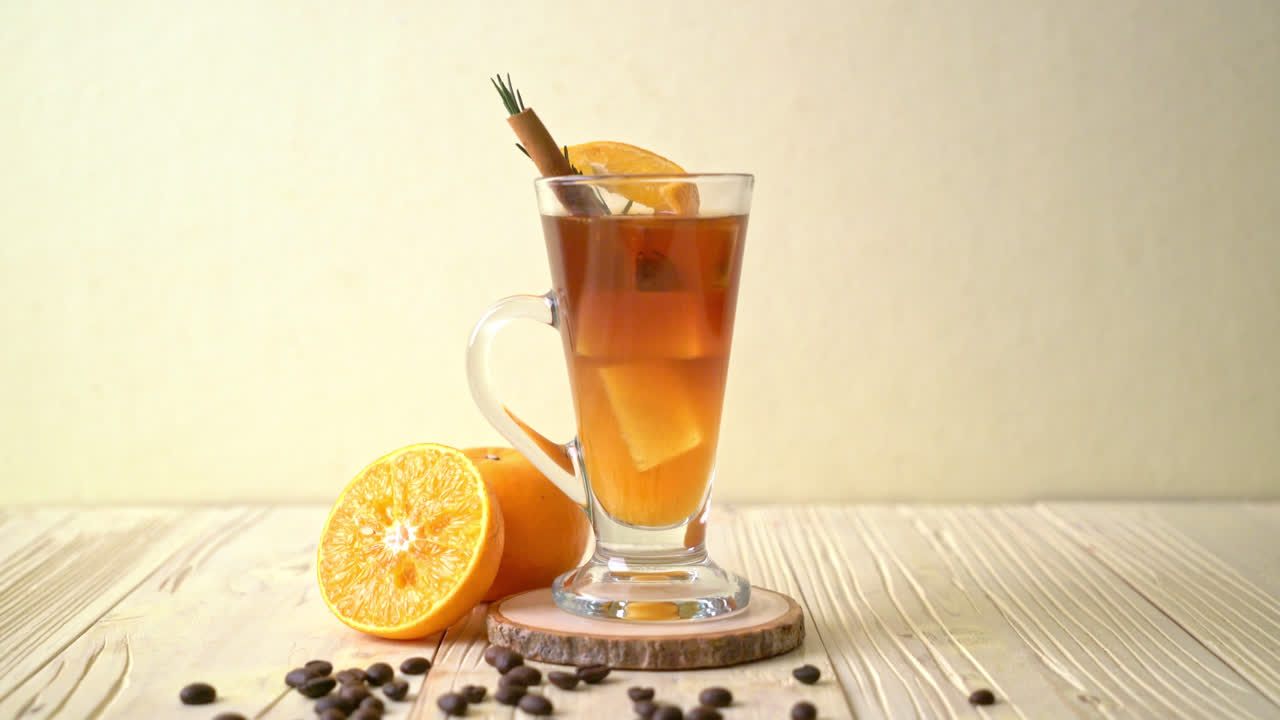 A Glass Of Iced Americano Black Coffee And Layer Of Orange And Lemon Juice  Decorated With Rosemary And Cinnamon Free Stock Video Footage Download Clips