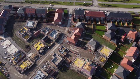 drone aerial view of house building site in cheshire, england, uk, europe, illustrating urban development due to housing shortage in the uk.