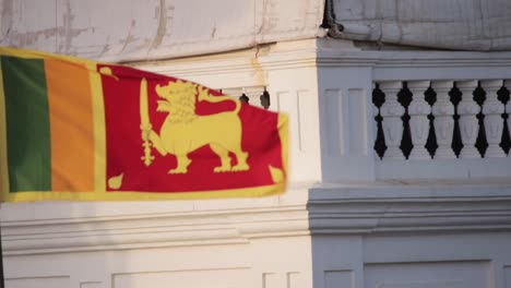 Sri-Lankan-National-Flag-blowing-in-the-wind-smooth-right-to-left-pan-b-roll-video-clip-slow-motion-in-Galle-Fort-Evening