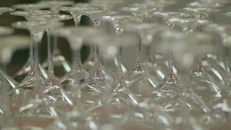 view of many up turned wine glasses ready for quality control in glass factory