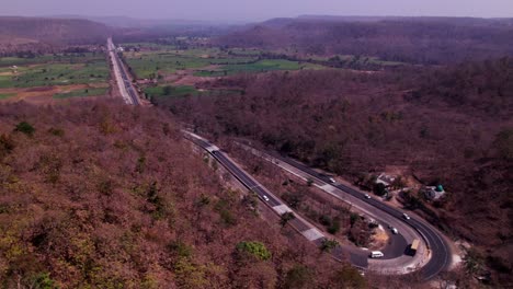 forest with road and farming land at day time, push back, drone shot, 4k.