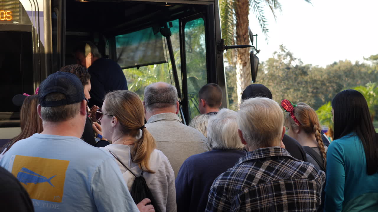 people getting on a bus.