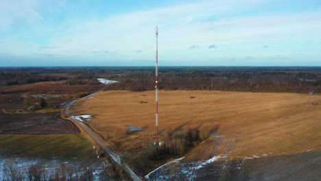 aerial view of telecommunication tower in wide landscape with farmland