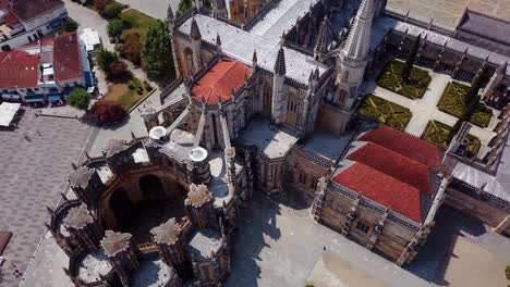 aerial tilting shot of the unfinished chapel and the batalha monastery, portugal