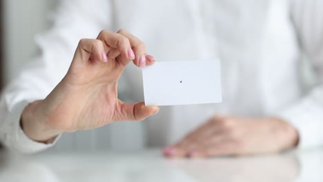 white business card in hands of business person closeup