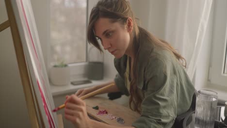 woman painting in a home studio