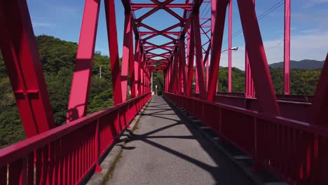 cycling over red steel bridge on the shimanami kaido, hiroshima japan