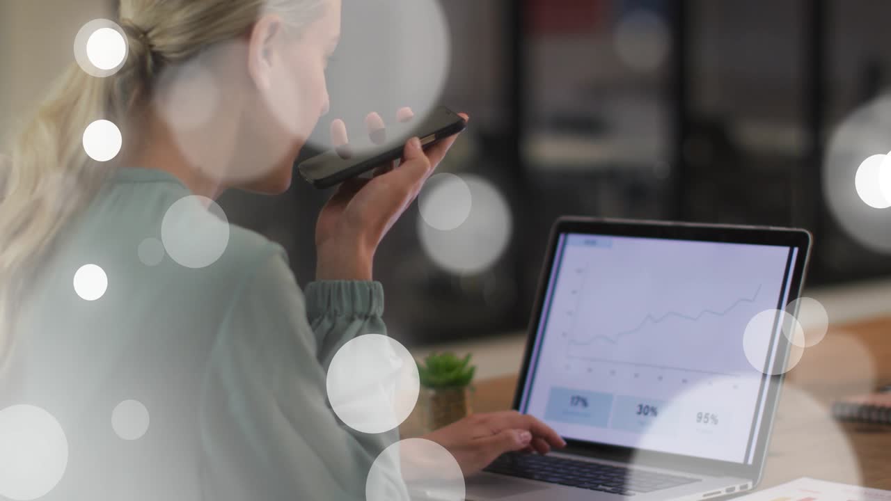 Woman reaching smartphone, dictating charts, typing laptop business, bokeh overlay obscuring scene