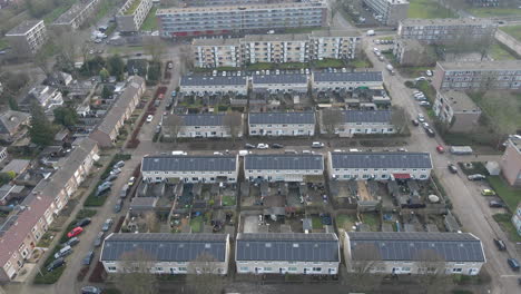 flying over residential neighbourhood with solar panels on rooftop