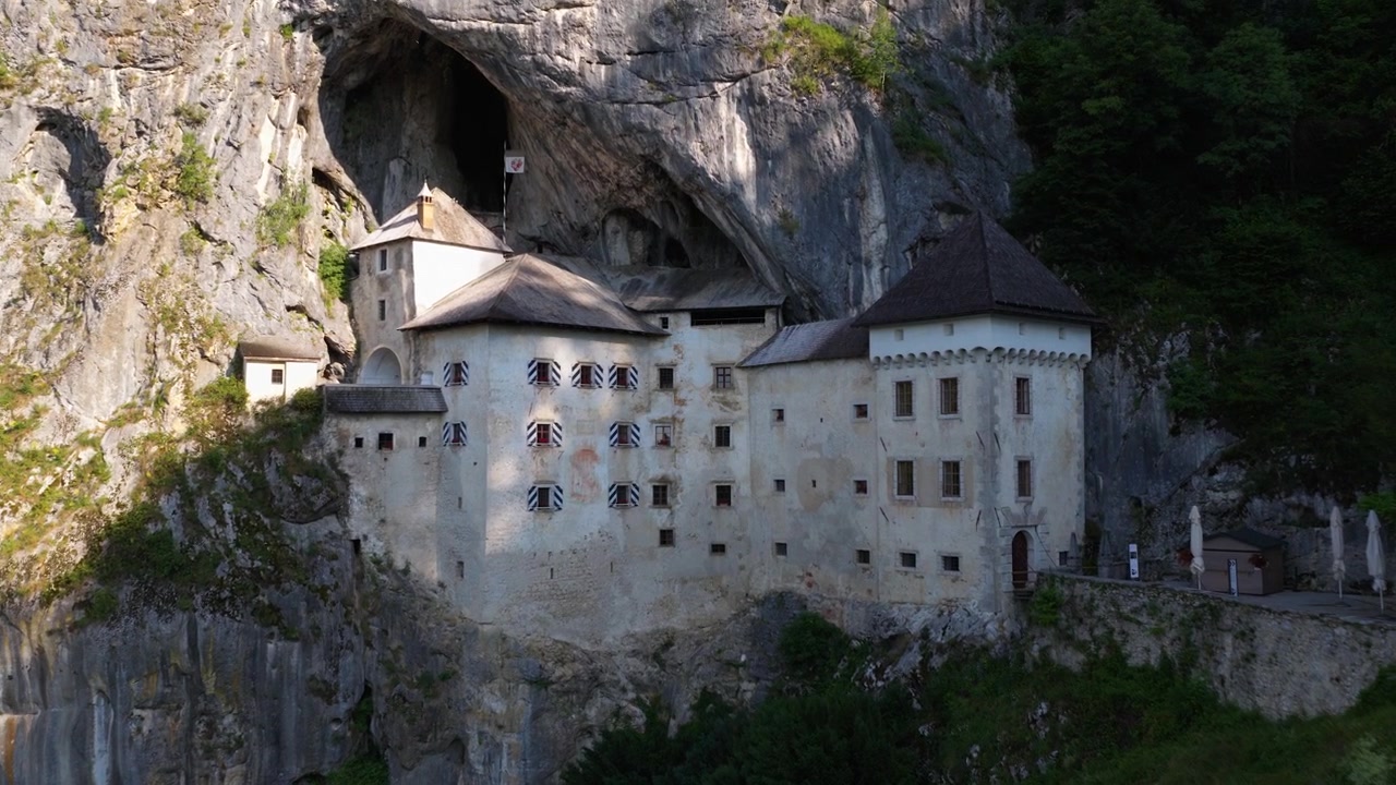 Predjama Castle built in the mountain, a famous touristic landmark in Slovenia - drone shot