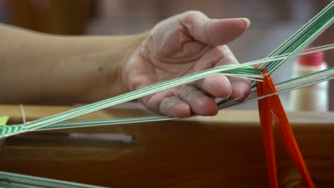 Fingers-separating-green-and-white-strings-and-pressing