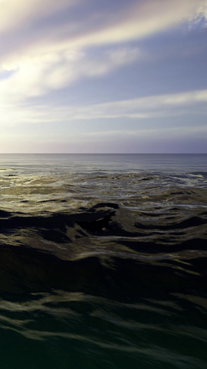 Calm waves dance beneath a colorful sky at sunset near the tranquil coast