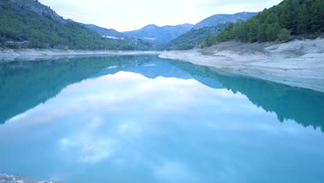 serene mountain lake reflection with person taking photo