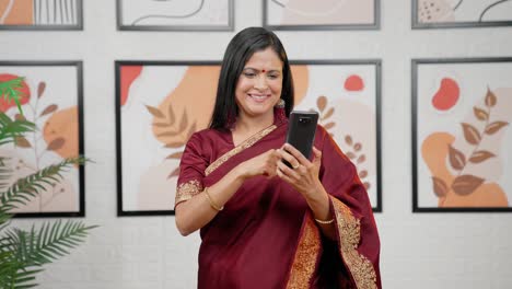 Happy-Indian-woman-scrolling-phone