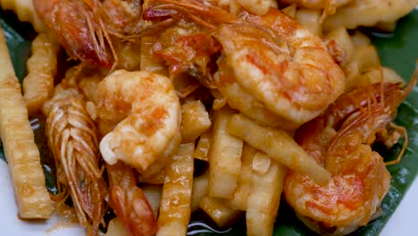 close-up footage of stir fried prawn and young coconut shoot, one of thai comfort food