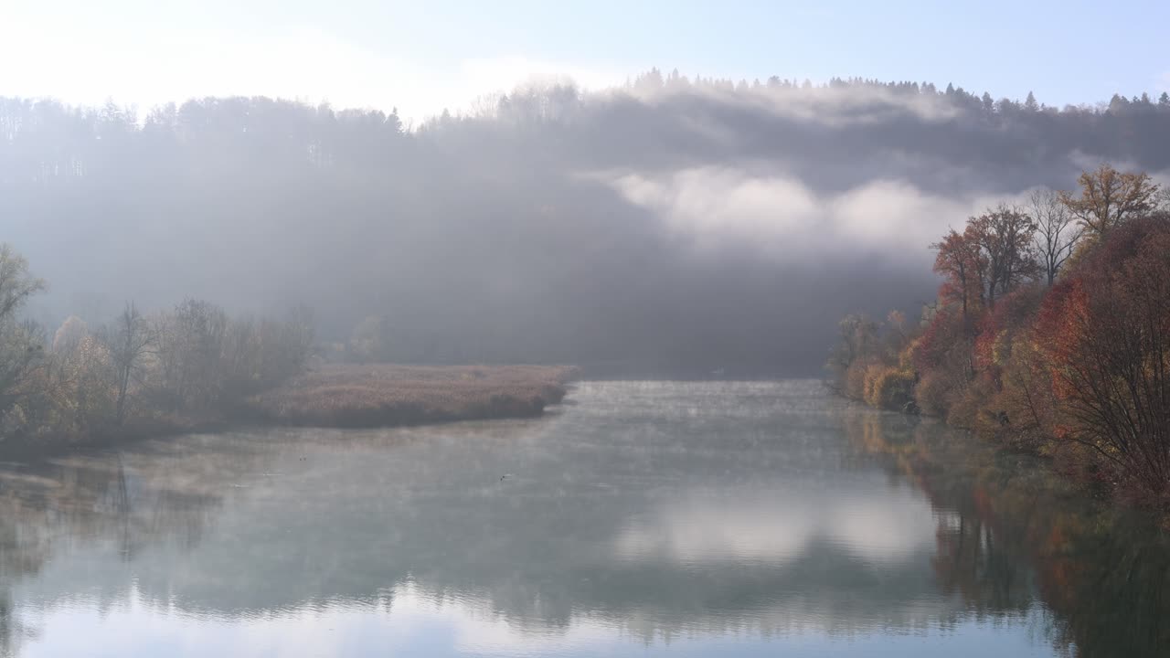 Foggy lake with mysterious fall ambience, background establisher