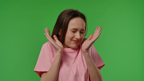 teenager covering ears, looking unhappy