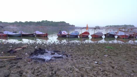 ashes of burnt human body at triveni sangam, the confluence of the ganges and the yamuna rivers in prayagraj