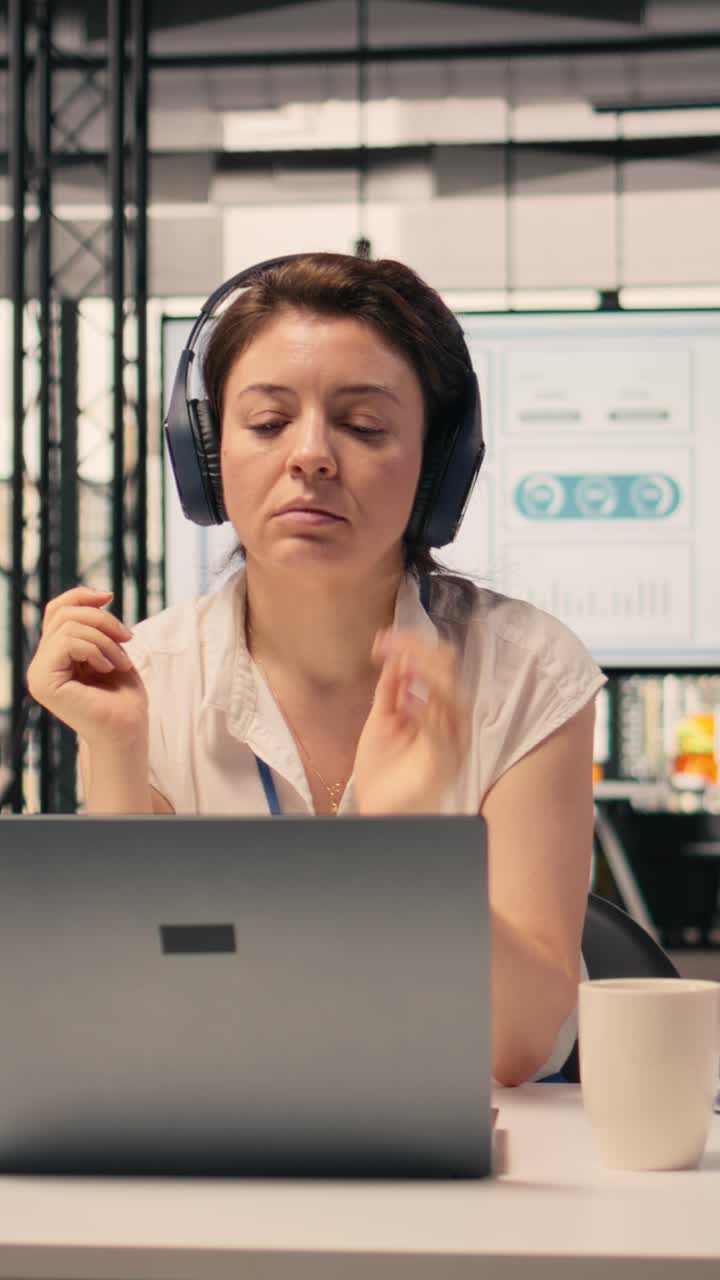 Vídeo vertical: mujer de negocios escuchando música con auriculares inalámbricos