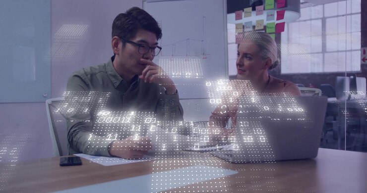 Business Professionals Collaborating on Data Analysis in Modern Office