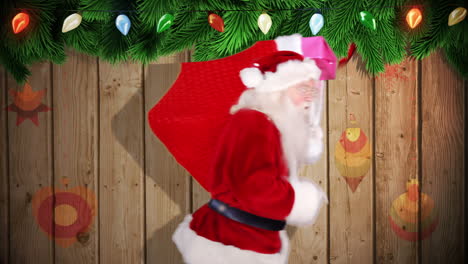 santa carrying sack of gifts against festive wooden background