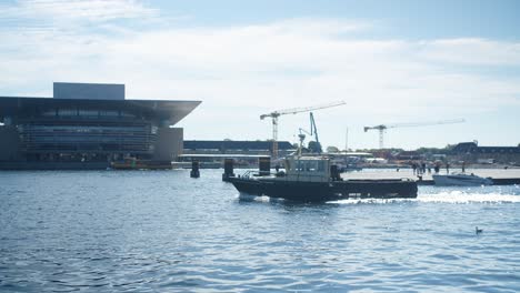 boat sailing by copenhagen opera house, denmark