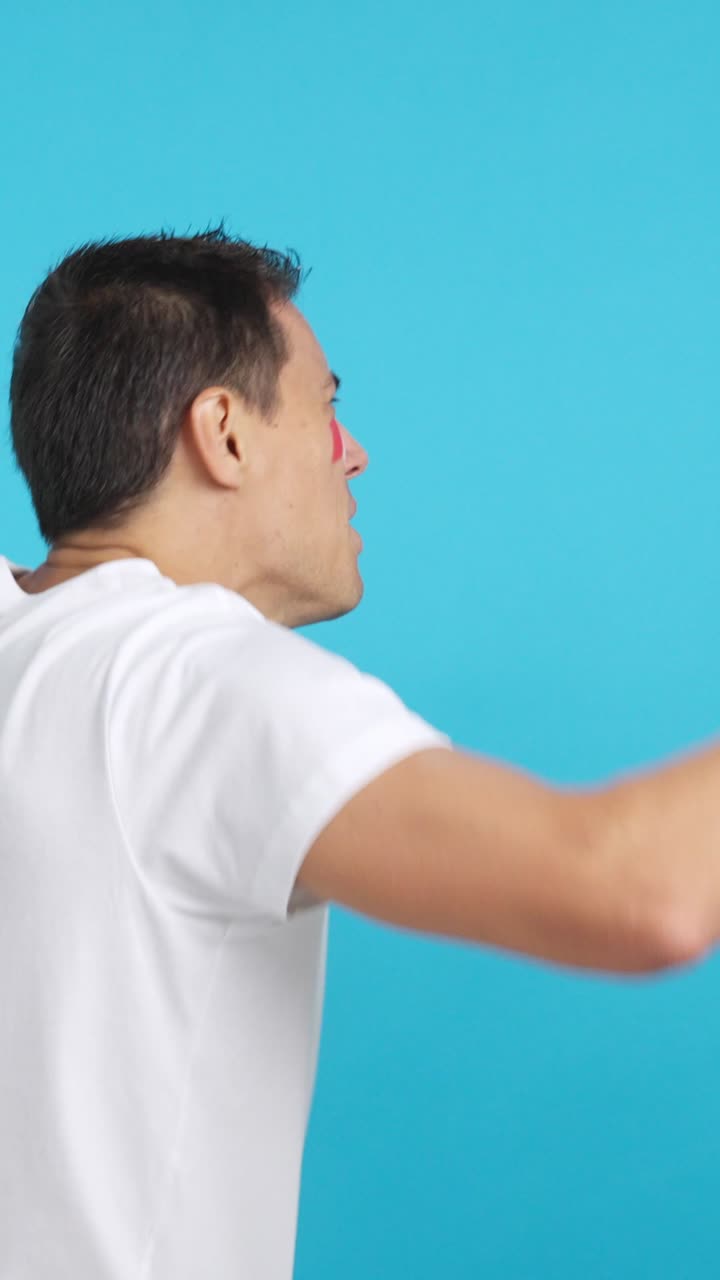 Rear view of a man waving a peruvian pennant
