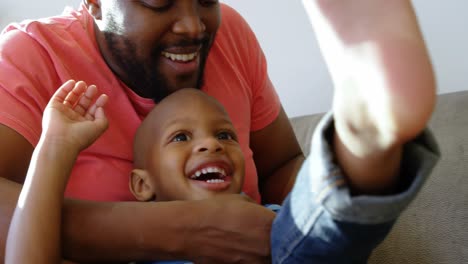 father and son having fun in a comfortable home 4k