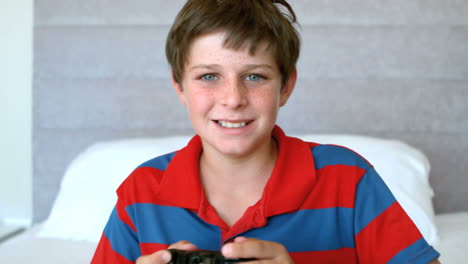 concentrated young boy playing video games