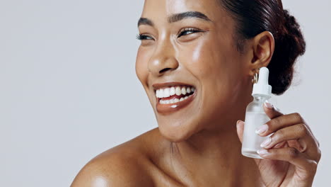 woman holding skincare serum bottle