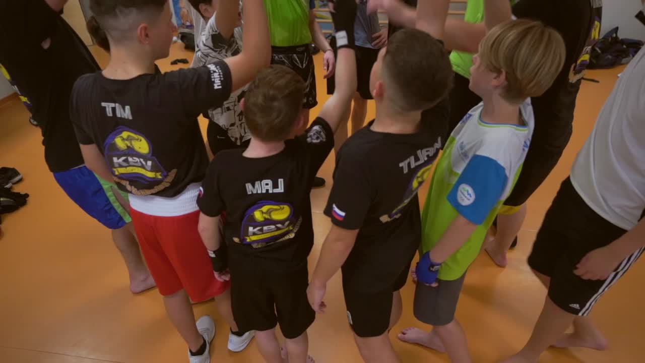 Slow motion  video of a young boxer. kid hoping rope. Activity children training for boxing game. Boxer trainer with children.