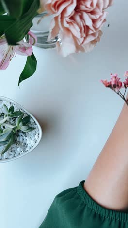 floral arrangement with woman's hand