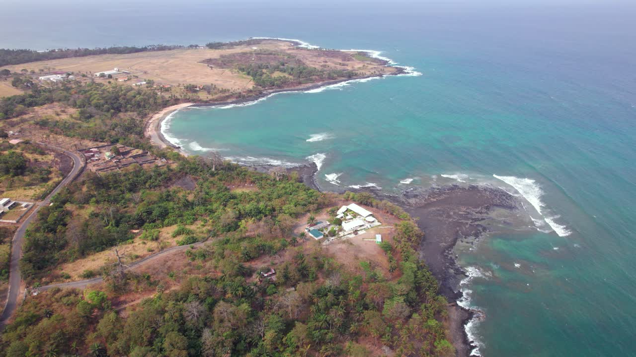 Scenic Tropical Beach with Palm Trees and Lava Rocks in São Tomé and Principe