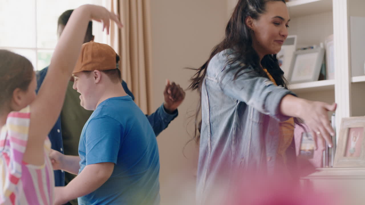 happy multiracial family dancing at home having fun enjoying dance celebrating exciting weekend together
