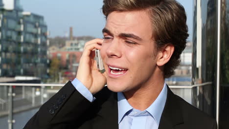 happy businessman talking on mobile phone outdoors