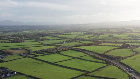 expansive aerial shot showcasing the vivid and lush green ireland countryside