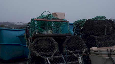 Lobster-pots-near-the-harbour-of-Mevagissey-Harbour,-Cornwall,-England,-UK-on-an-overcast-day