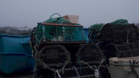 lobster pots near the harbour of mevagissey harbour, cornwall, england, uk on an overcast day